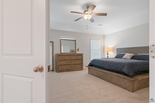 bedroom featuring ceiling fan and light carpet