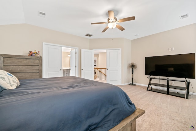 carpeted bedroom featuring ceiling fan, connected bathroom, and vaulted ceiling