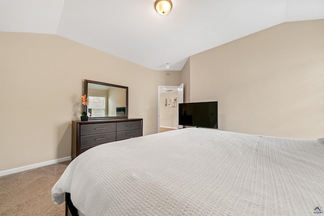 bedroom with vaulted ceiling and carpet flooring