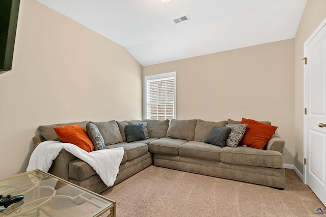 carpeted living room with vaulted ceiling