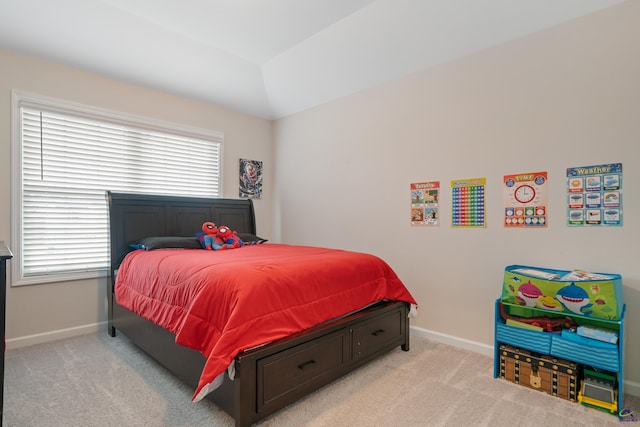 carpeted bedroom with lofted ceiling