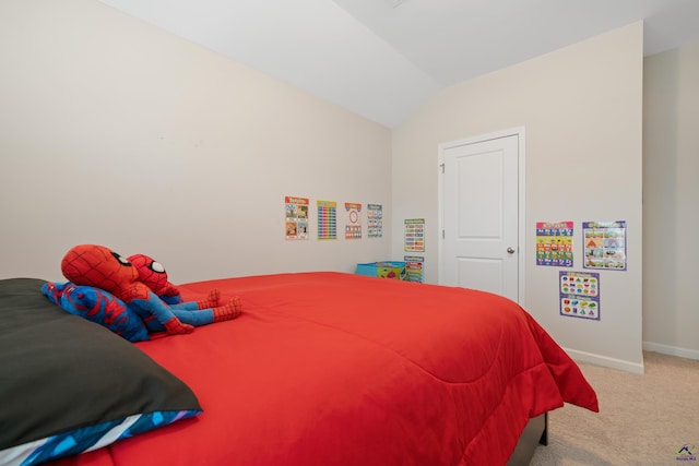 carpeted bedroom featuring lofted ceiling