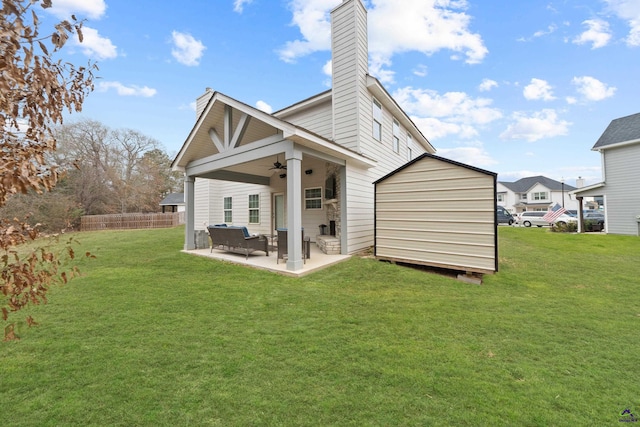 back of property featuring a patio area, a lawn, and ceiling fan