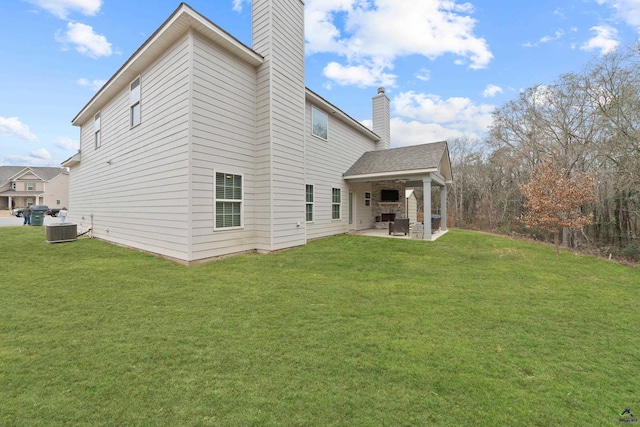 rear view of property with a patio area, central AC unit, and a lawn