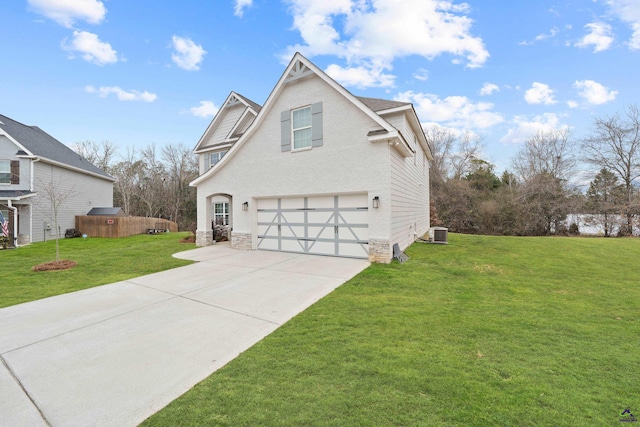 front facade featuring a garage, a front lawn, and central air condition unit