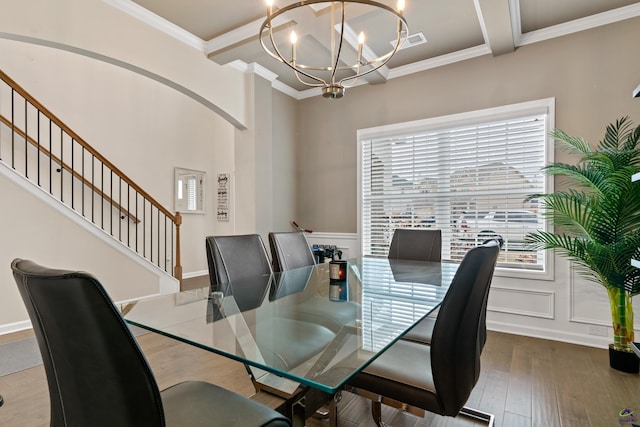 dining room featuring ornamental molding, hardwood / wood-style flooring, beamed ceiling, and an inviting chandelier