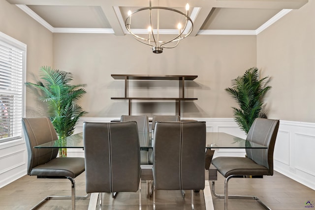 dining room featuring a notable chandelier, beamed ceiling, coffered ceiling, light wood-type flooring, and ornamental molding