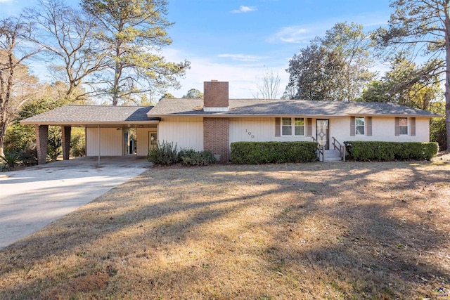 ranch-style house with a front yard and a carport