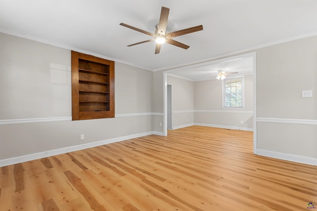 empty room with built in shelves, light hardwood / wood-style flooring, ceiling fan, and ornamental molding