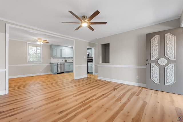 unfurnished living room featuring ceiling fan, light hardwood / wood-style flooring, and ornamental molding