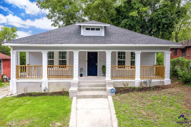 bungalow featuring a porch and a front yard