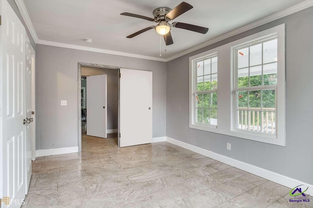 empty room with ornamental molding and ceiling fan