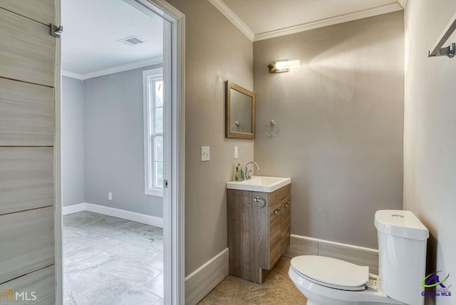 bathroom with vanity, plenty of natural light, crown molding, and toilet