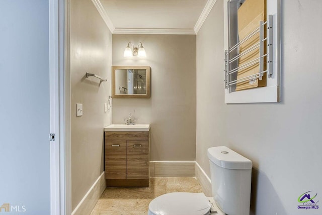 bathroom featuring vanity, ornamental molding, and toilet