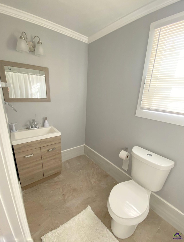 bathroom featuring vanity, tile patterned floors, crown molding, and toilet