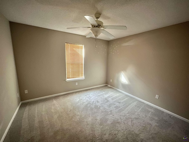 carpeted empty room featuring a textured ceiling and ceiling fan