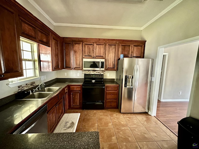 kitchen featuring sink, light tile patterned floors, appliances with stainless steel finishes, and ornamental molding