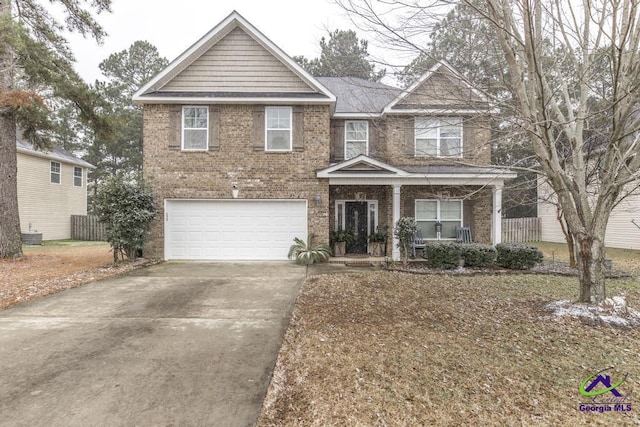 view of front of property featuring a garage and covered porch