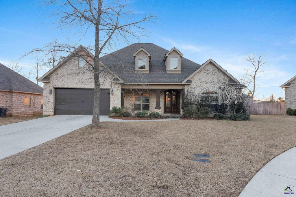 view of front of home with covered porch and a garage