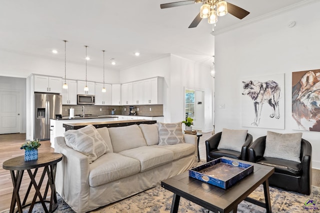 living room featuring ceiling fan and light hardwood / wood-style floors