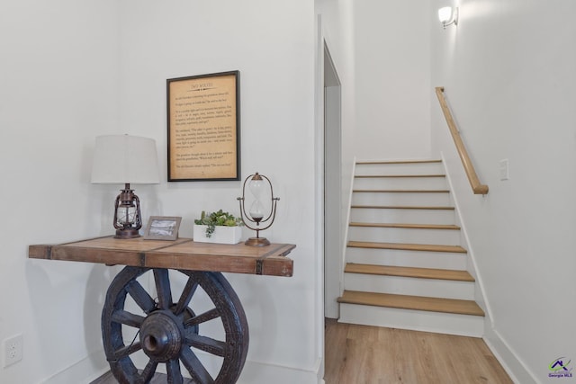 staircase with hardwood / wood-style floors