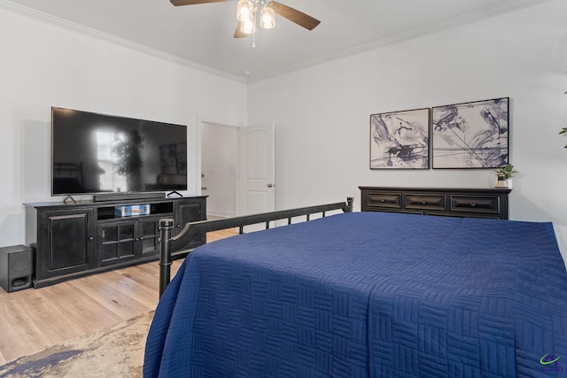 bedroom featuring ceiling fan, wood-type flooring, and ornamental molding