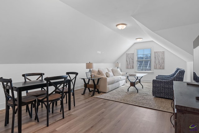 living room featuring light hardwood / wood-style flooring and vaulted ceiling