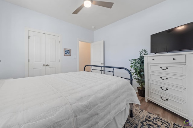 bedroom with ceiling fan, dark hardwood / wood-style flooring, and a closet