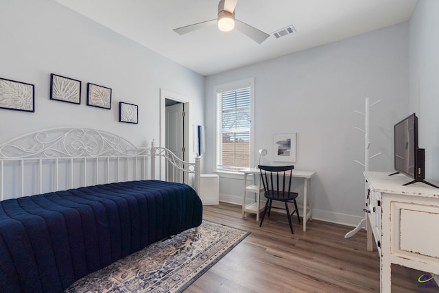 bedroom with dark hardwood / wood-style floors and ceiling fan