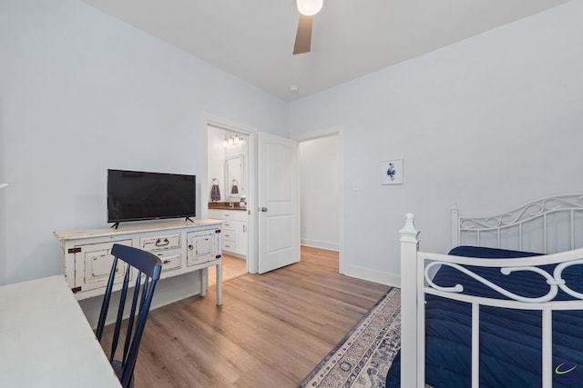 bedroom featuring connected bathroom, light hardwood / wood-style flooring, and ceiling fan