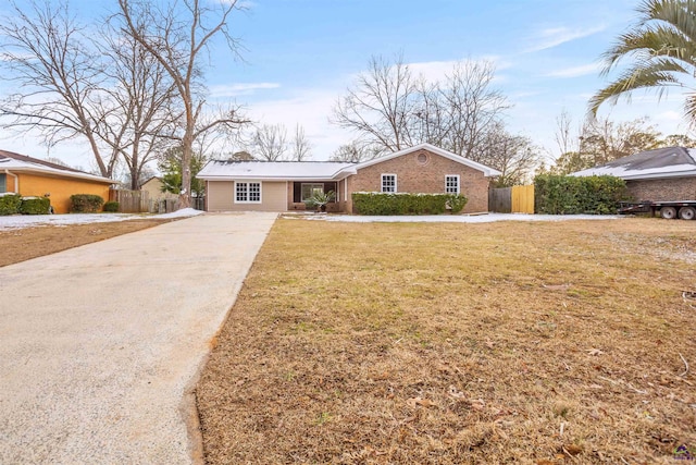 ranch-style home featuring a front yard