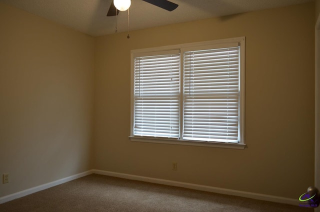 carpeted empty room featuring a textured ceiling and ceiling fan