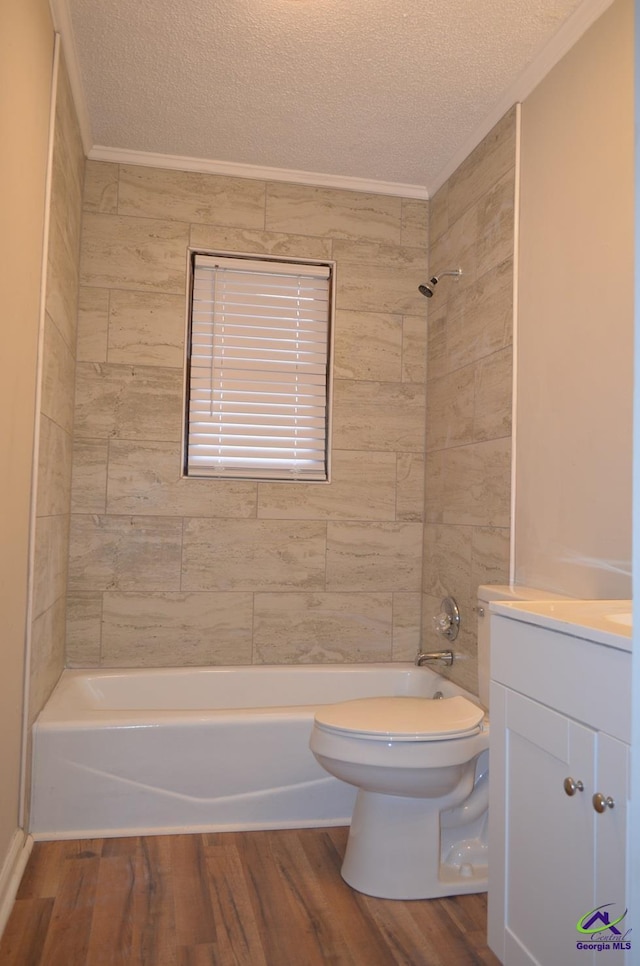 full bathroom featuring tiled shower / bath, wood-type flooring, and a textured ceiling