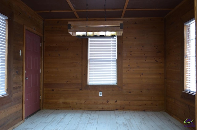 empty room featuring wood walls