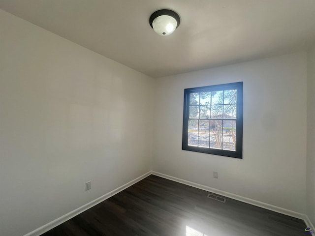 spare room with dark hardwood / wood-style flooring