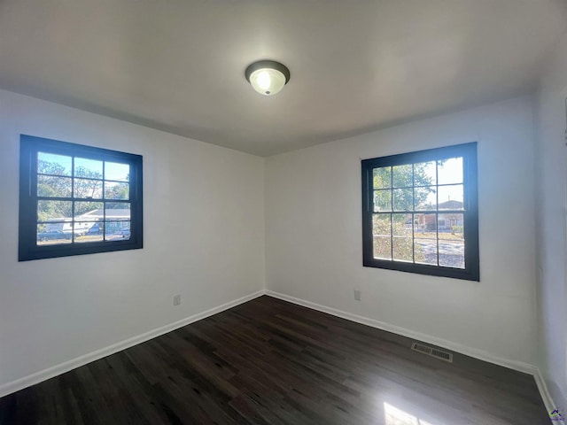 spare room featuring dark hardwood / wood-style flooring