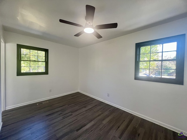 empty room featuring ceiling fan and dark hardwood / wood-style flooring