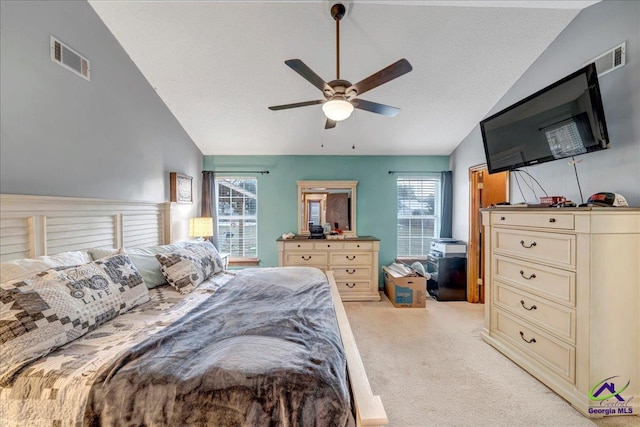 bedroom with vaulted ceiling, light colored carpet, and ceiling fan