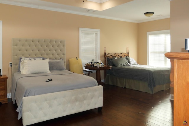 bedroom with crown molding, dark hardwood / wood-style floors, and a skylight