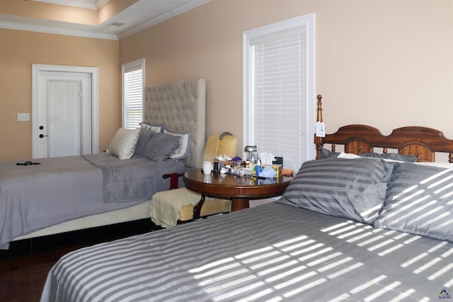 bedroom with dark wood-type flooring and ornamental molding