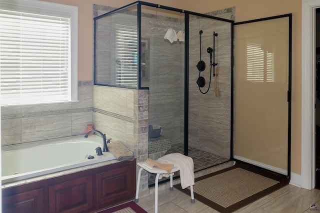 bathroom featuring independent shower and bath