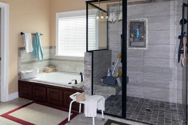 bathroom featuring shower with separate bathtub