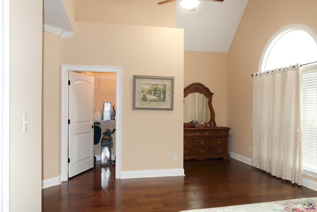 interior space with lofted ceiling, dark wood-type flooring, and ceiling fan