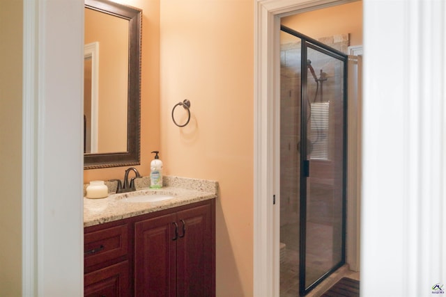 bathroom featuring vanity and an enclosed shower