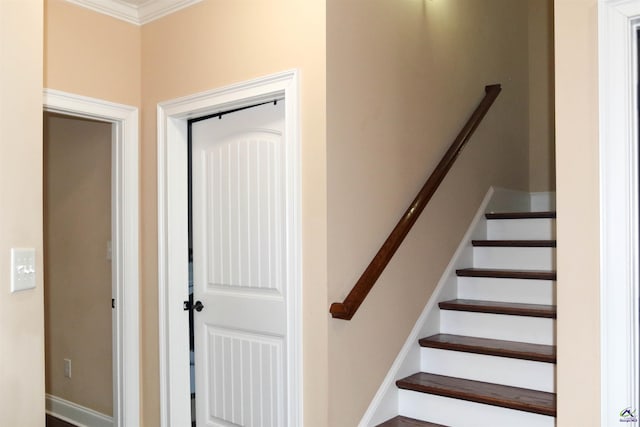 stairs featuring crown molding