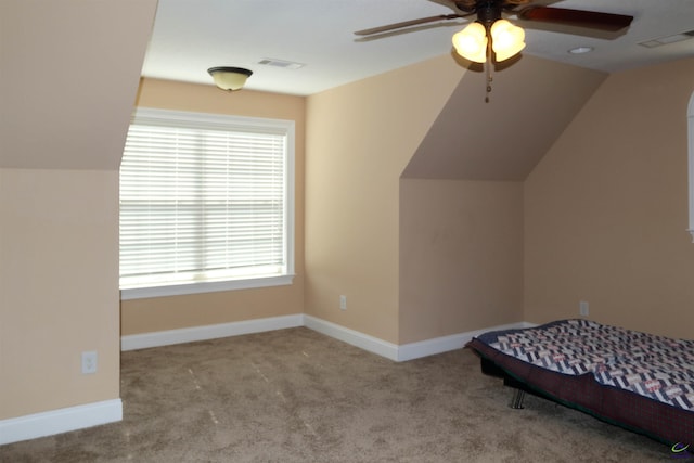 unfurnished bedroom with light carpet, lofted ceiling, and ceiling fan