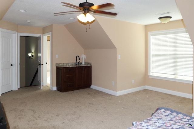 bonus room with light carpet, vaulted ceiling, and ceiling fan