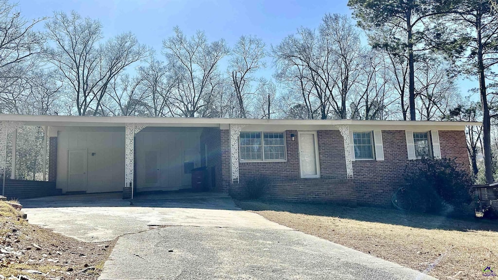 single story home featuring a carport