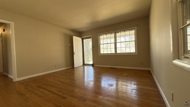 empty room with hardwood / wood-style floors