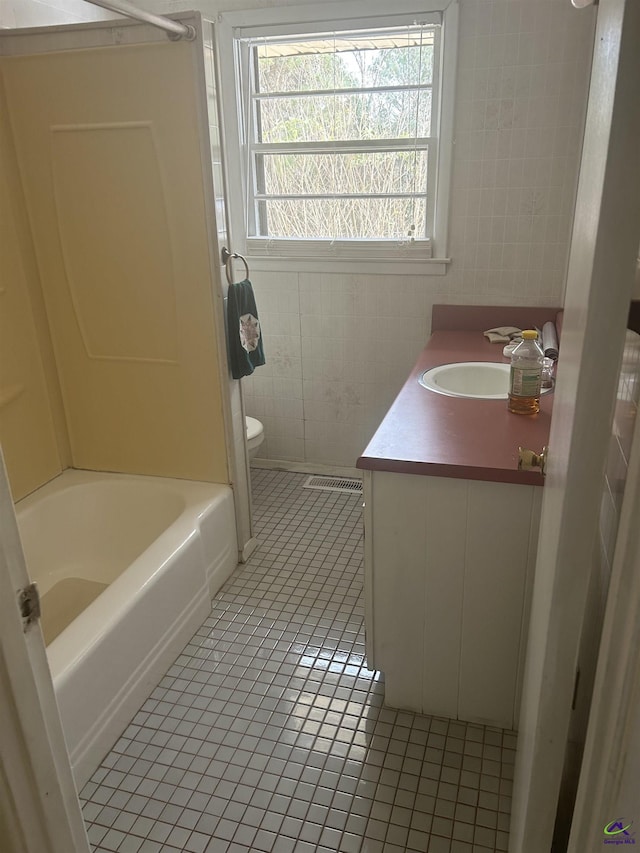 bathroom featuring tile patterned floors, toilet, and vanity